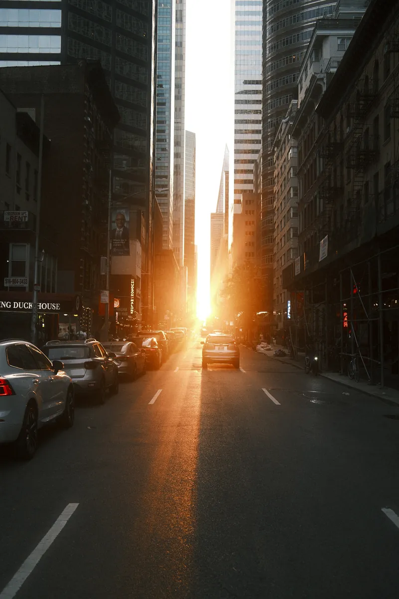 Low sun burning down a Midtown street between towers